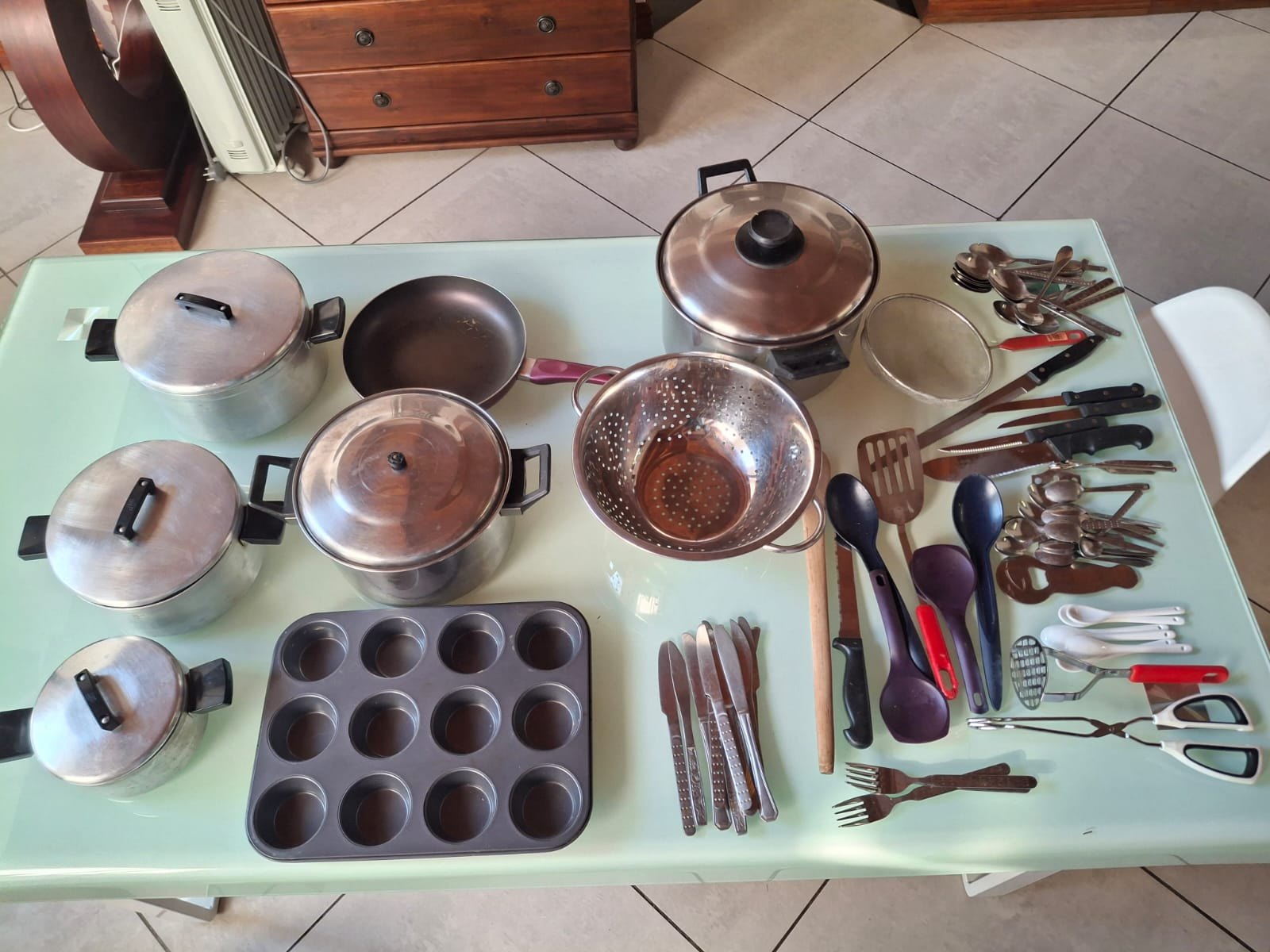 Lot 01 — Mixed Kitchenware: pots & lids, non-stick pan, colander, 12-cup muffin tin + cutlery & utensils