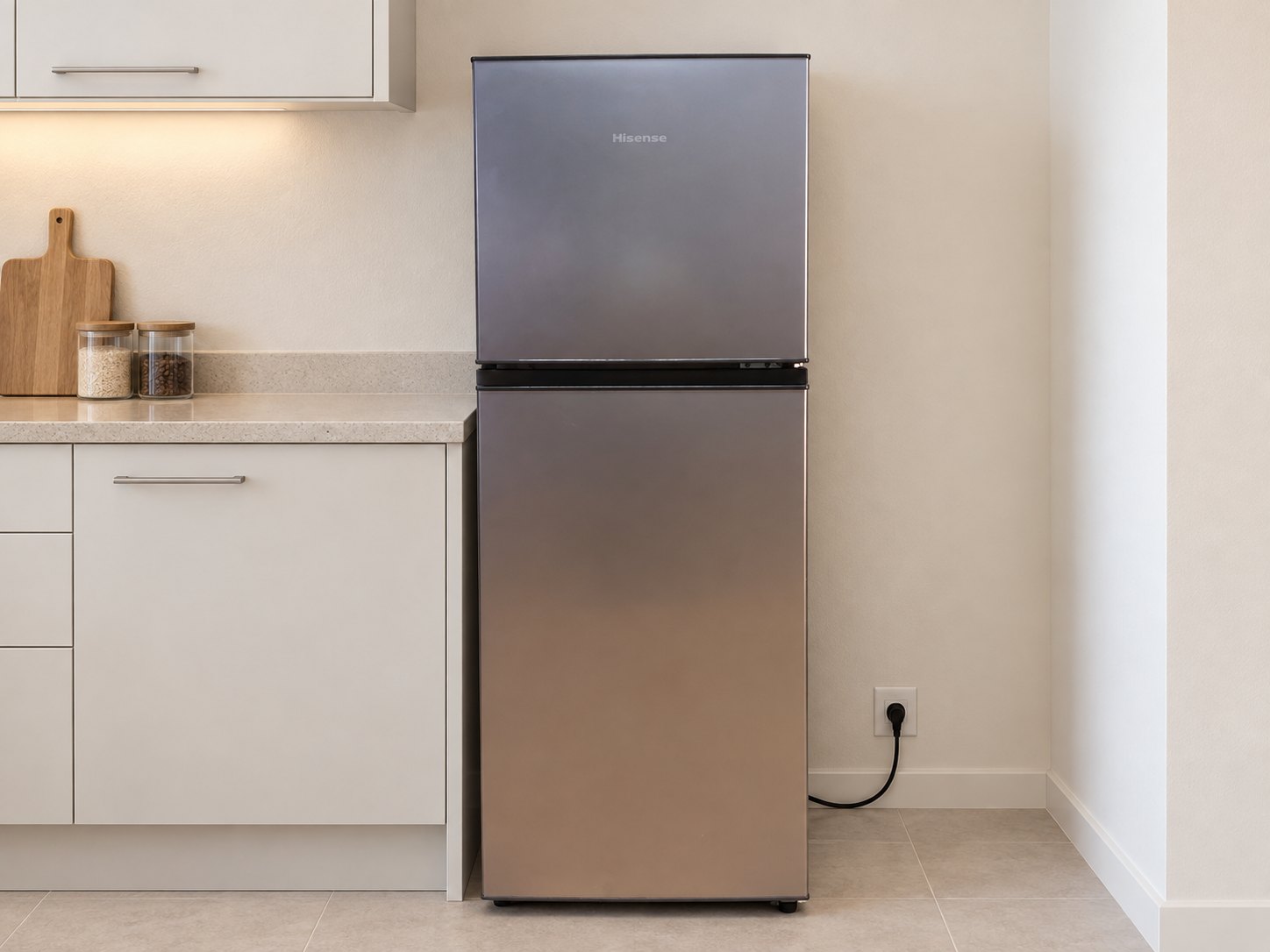 Hisense H225TTS top‑freezer refrigerator — labelled 154L, stainless finish, shelves & bins present, working