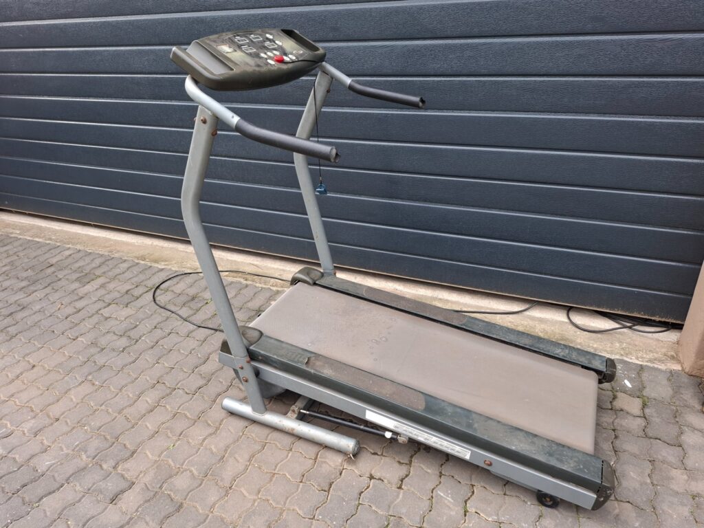 Explore treadmill with Trojan console — belt runs, requires new plug; heavy wear & broken panels