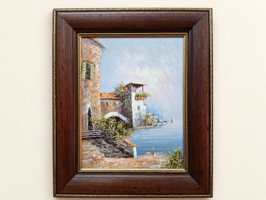 Signed coastal oil-on-board (appears ‘Reynolds’) — framed, 55 x 46 x 3 cm