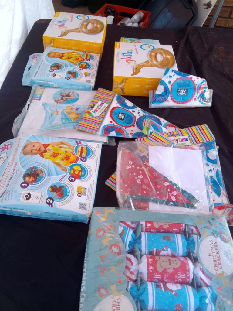 Mixed lot: Intex boxed inflatables (mermaid tube, wet set, baby ring) + party decorations — mostly new, some box wear