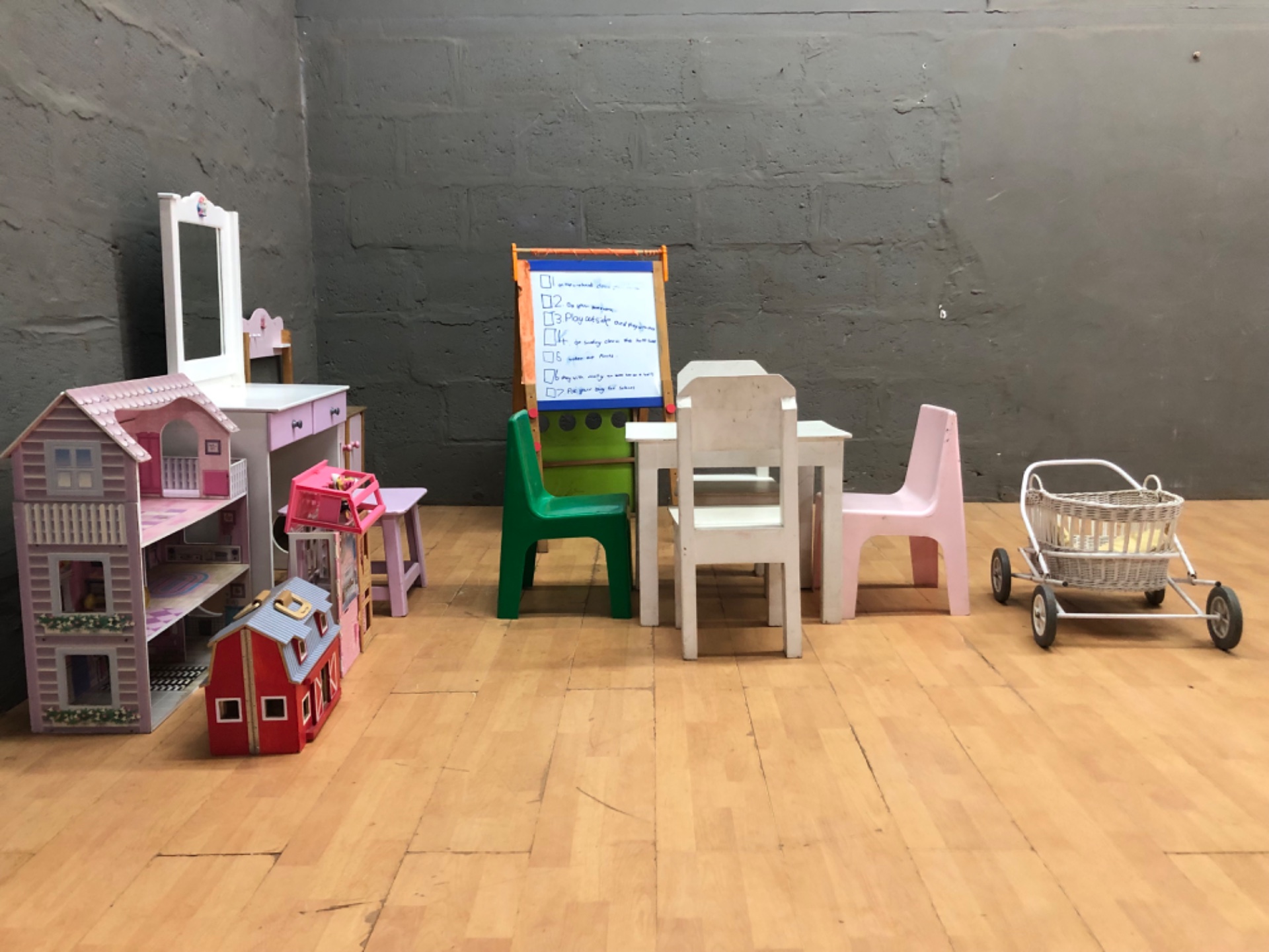 Mixed children’s play furniture & dollhouse lot — table, chairs, vanity, toy kitchen, pram (used, scuffed)