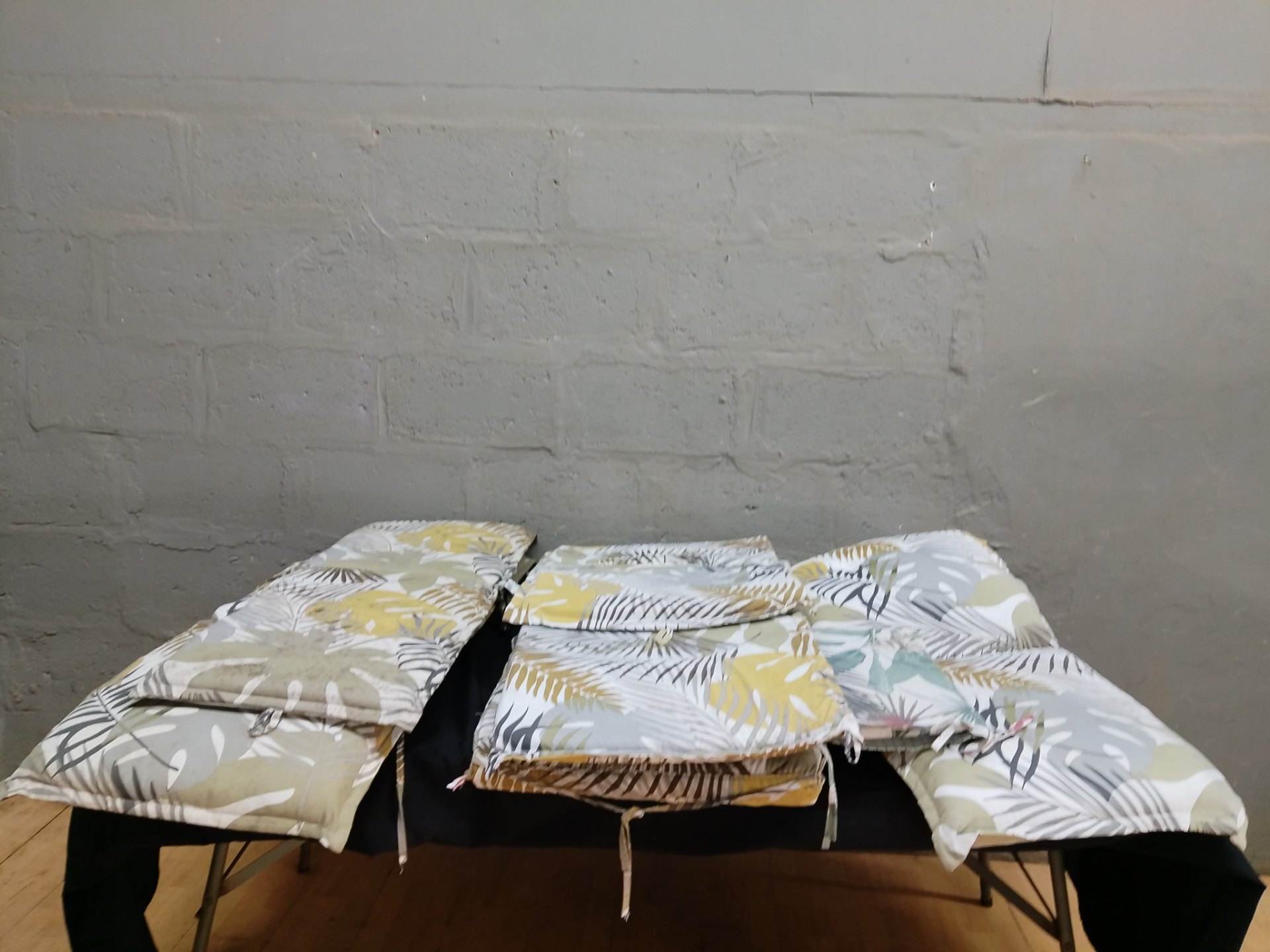 Lot of patterned seat/bench cushions with ties — used, visible staining