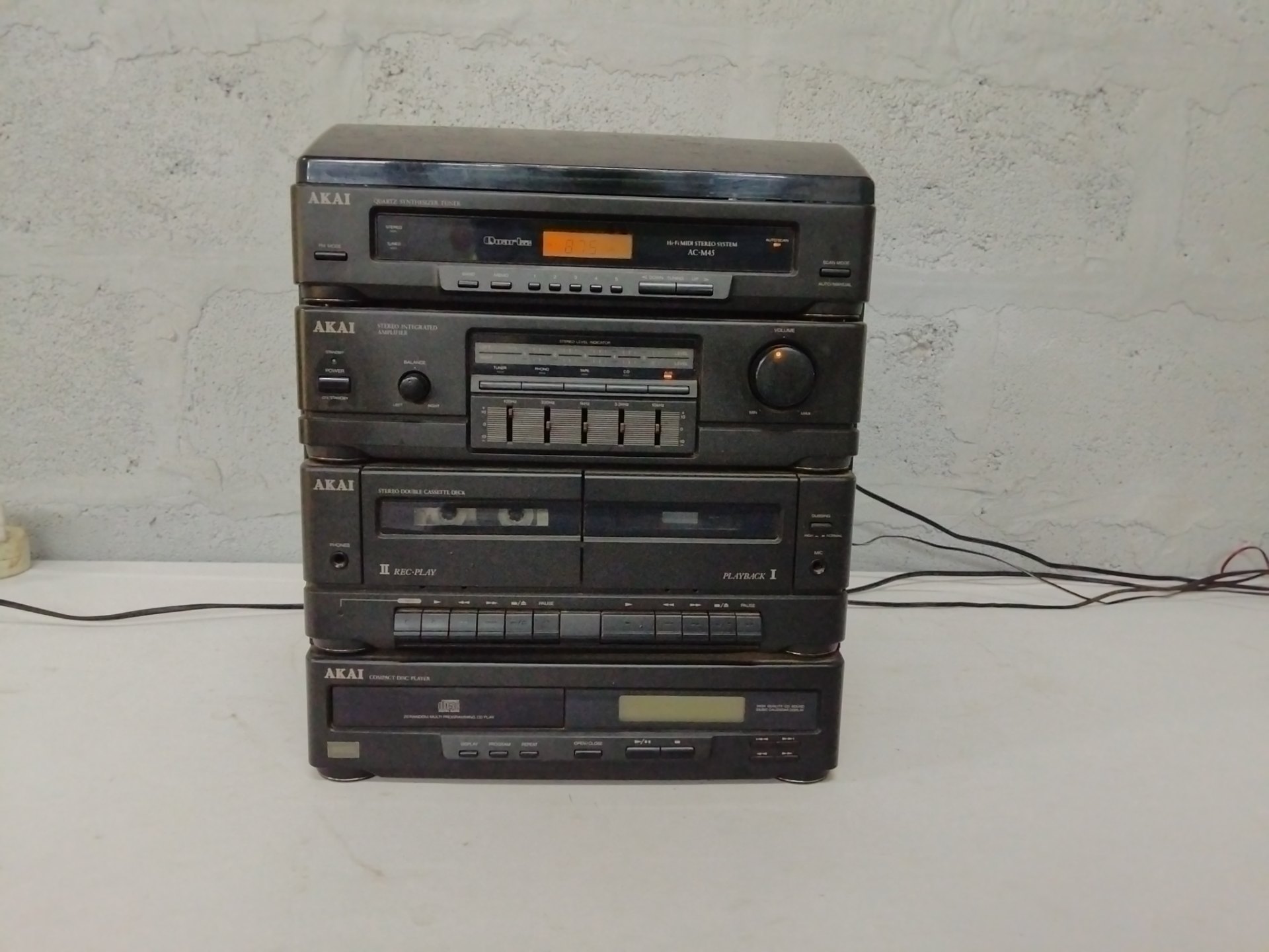 AKAI stacked Hi‑Fi system (AC‑M45 tuner) — tuner, amp, CD, double cassette & turntable
