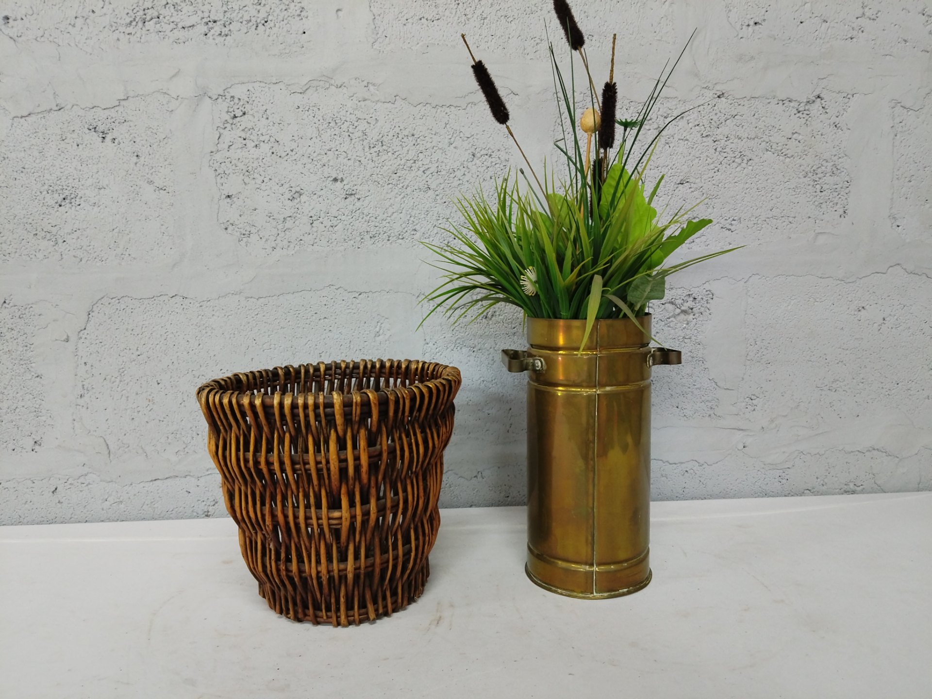 Mixed decorative lot: tall brass cylindrical vase with artificial plant (fixed) + woven wicker basket