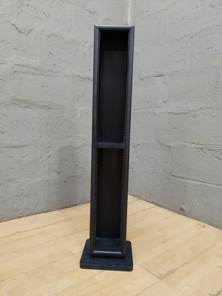 Tall narrow wooden CD/DVD/media tower on square base — internal slotted rails