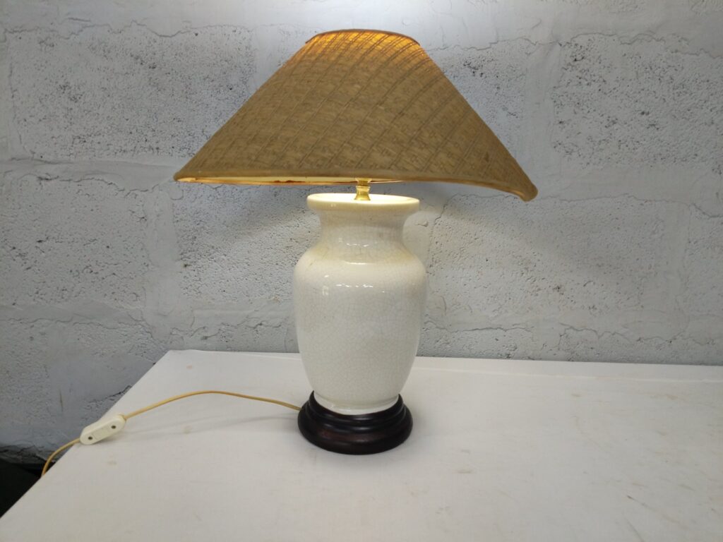 White glazed ceramic table lamp (crazed glaze) with woven cone shade on wooden plinth — tested working
