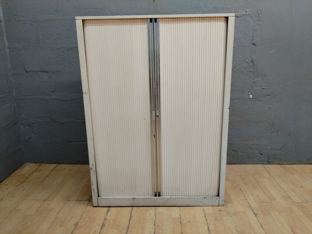 Cream tambour-door office storage cabinet – adjustable shelves, heavy wear & rust