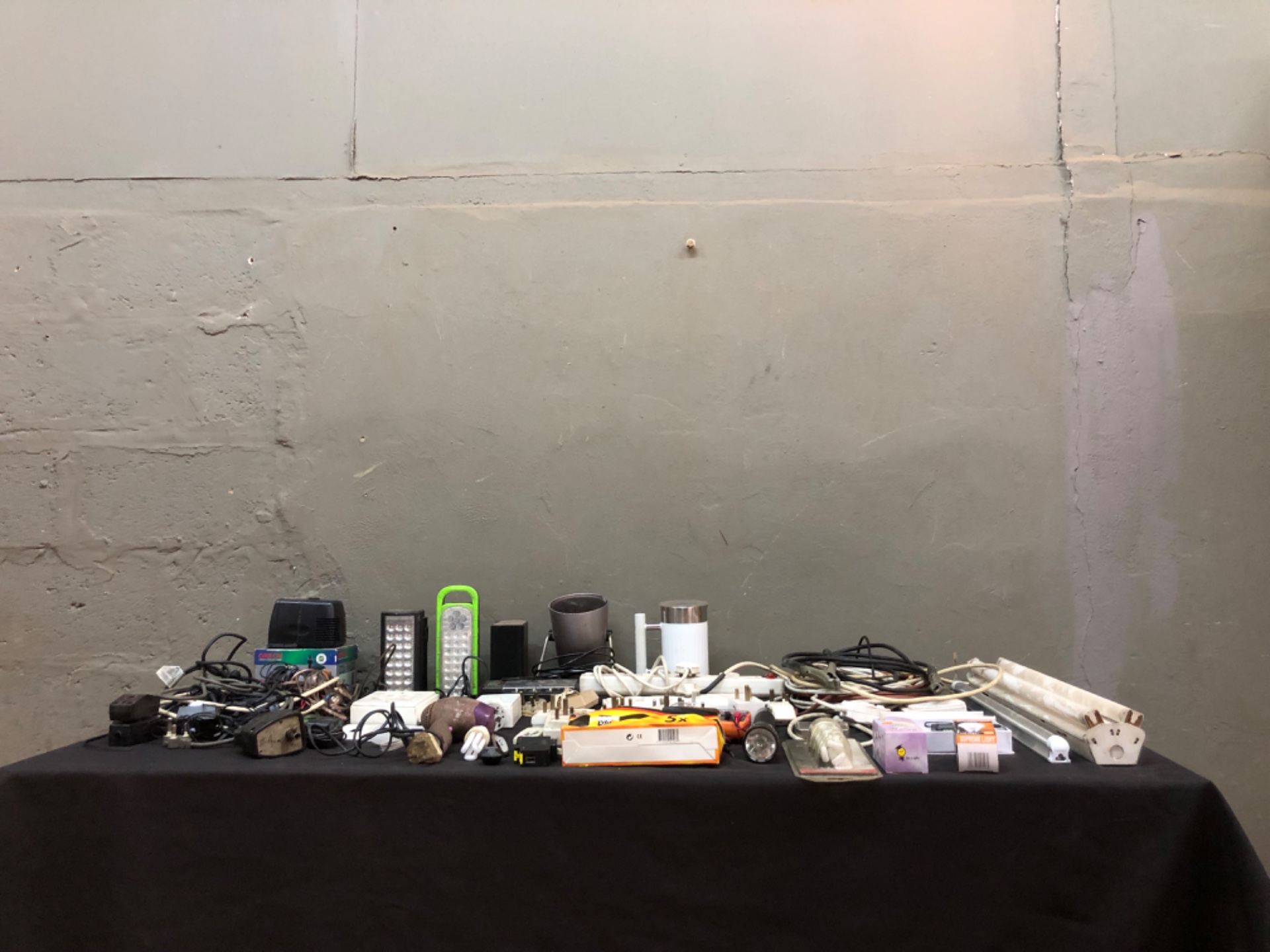 Mixed lot of 49 small electrical items — adaptors, powerboards, cables, bulbs, tubes, torches & multimeter